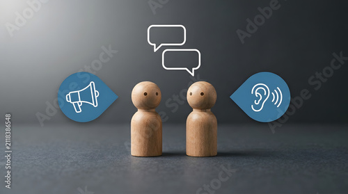 Two wooden peg figures with speech bubbles above, flanked by a megaphone and an ear with sound waves, symbolizing communication and active listening on a dark gradient background featuring dialogue