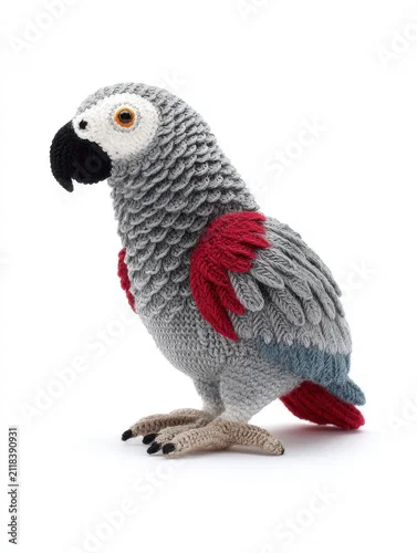 Fototapeta samoprzylepna Knitted Grey African Parrot Toy With Red Tail Isolated On White Background