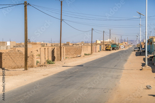 Atar city street in Mauritania, a small town in West Africa Sahel region, with dusty road during the hot summer day.
