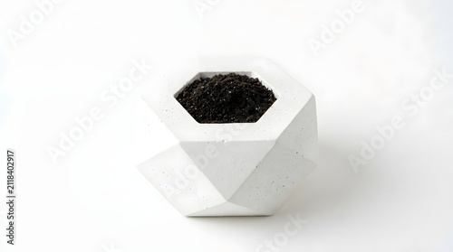Minimalist white geometric architectural prototype brick with dark soil