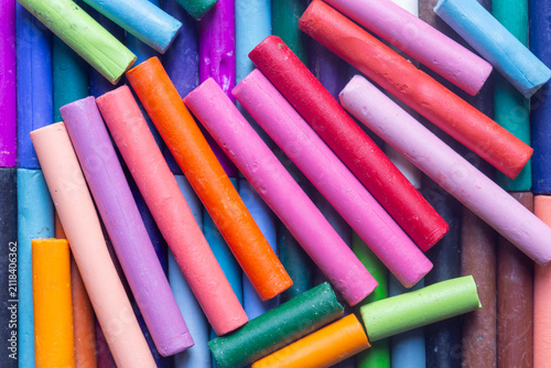 Фотография Pastels wax crayons, in various bright colours, background backdrop