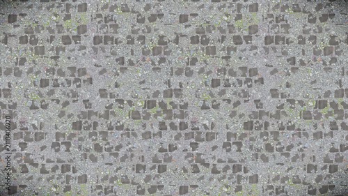 Abstract gray gravel and stone paving texture, seamless loop background.