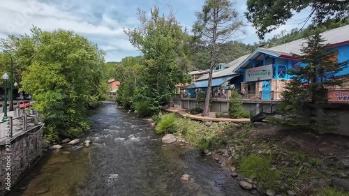 Little Pigeon River flowing tranquilly in front of Ripley’s Aquarium of the Smokies in Gatlinburg Tennessee