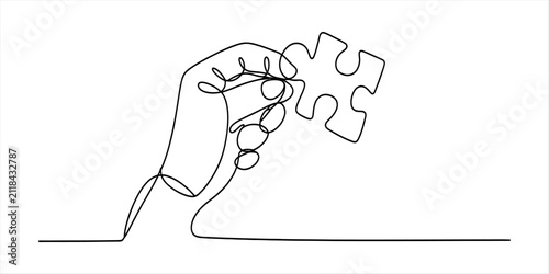 Fotografía Continuous line drawing of a human hand holding a single puzzle piece representi