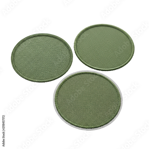 hyperrealistic macro close-up of three circular blank embroidered twill patches with matte forest green thread, showing merrowed, satin, and die-cut edges, isolated on a white background. commercial