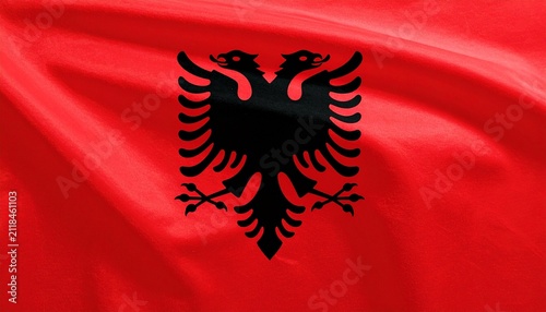 Albanian flag with red field and black double‑headed eagle emblem, symbolizing bravery, sovereignty, independence, resilience, and cultural identity…