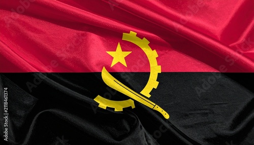 Angolan flag with red and black bands, yellow emblem of gear, machete, and star, symbolizing struggle, progress, unity, resilience…