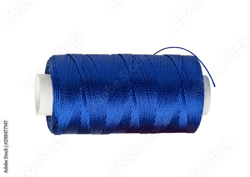 Cuadro en lienzo Dark blue sewing thread on white spool for textile manufacture.