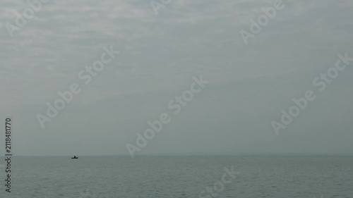 4K Lonely Fisherman on Lake on a Cloudy Overcast Day