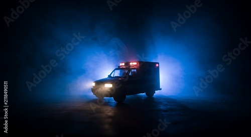 Emergency Ambulance Van with Blue and Red Lights in Foggy Night Scene