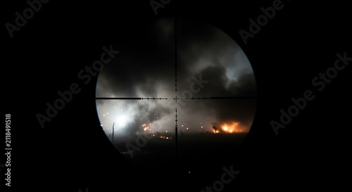 Nighttime Smoke and Fire Scene Viewed Through Rifle Scope Crosshairs