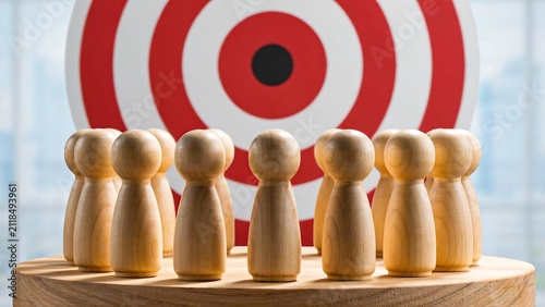 Wooden figures facing target symbol representing business goals and success concept