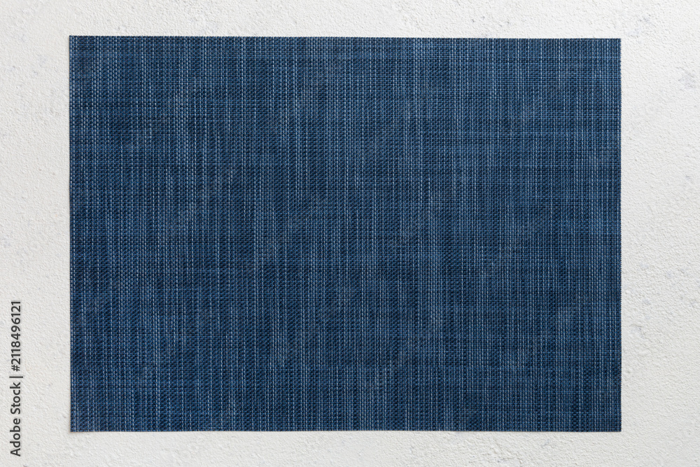 Obraz premium Top view of grey tablecloth for food on cement background. Empty space for your design