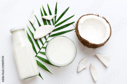 coconut products on white wooden table background. Dairy free milk substitute drink, Flat lay healthy eating