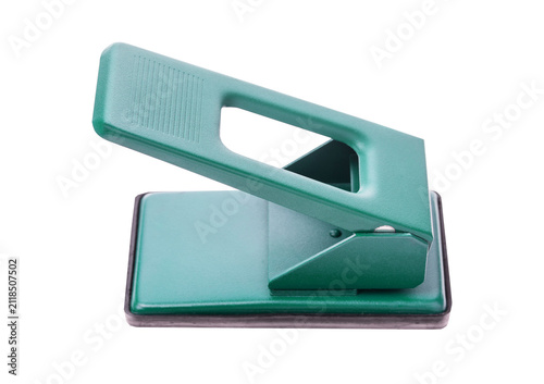 Konstfotografi Office stationery green hole puncher isolated on gray backdrop.