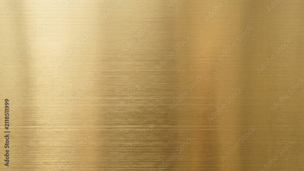 Fototapeta premium Brushed gold metal surface features a reflective warm metallic texture with subtle horizontal lines and soft light gradients across the polished plate.