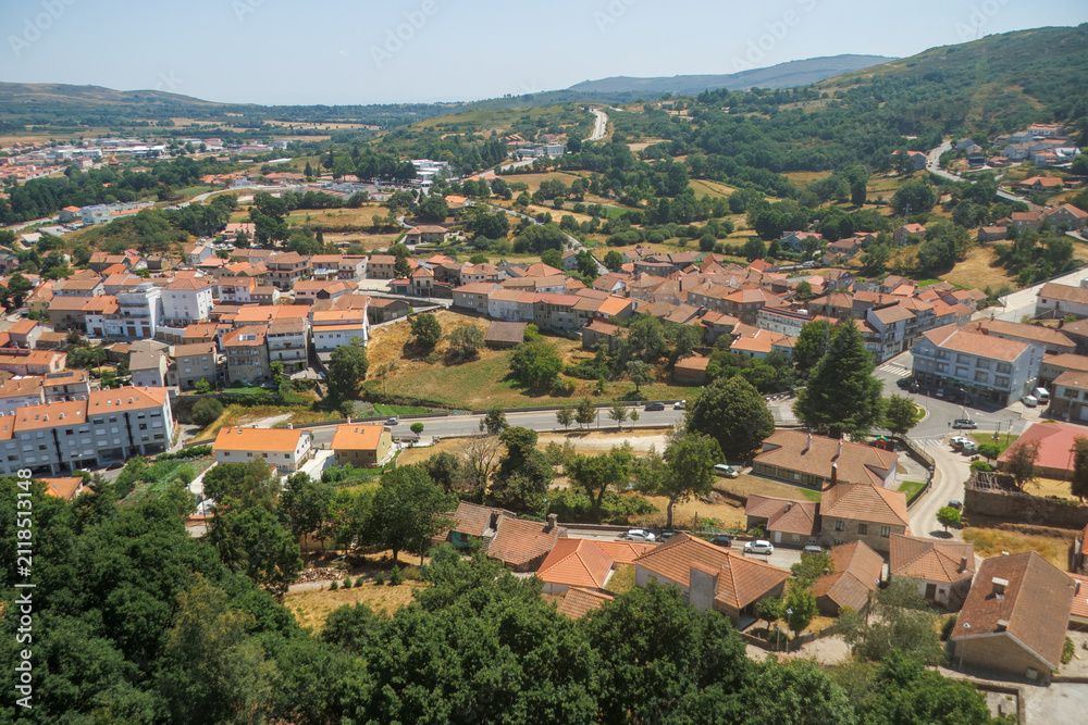 Fototapeta premium High angle panoramic view of the rural town of Montalegre in northern Portugal with traditional orange roofs and surrounding green hills. 