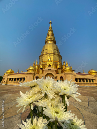 Flower offering held in hand at a temple on a sunny day.💐
