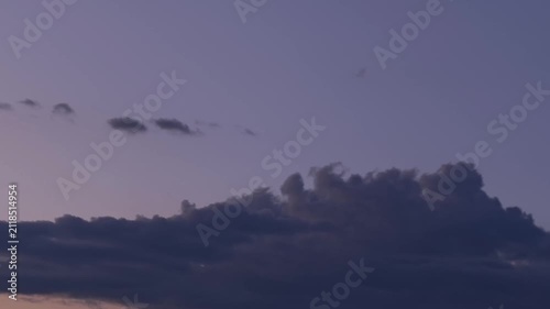 Amazing intense purple clouds in the sky at dusk