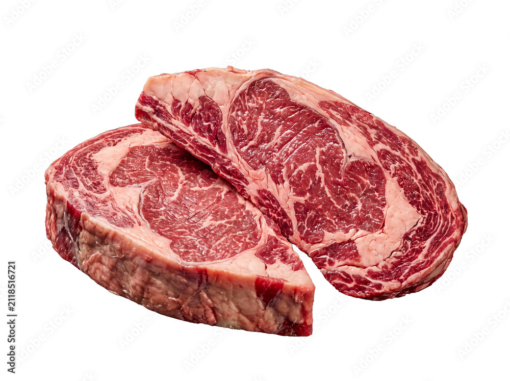 Fototapeta premium Two premium raw ribeye beef steaks, richly marbled for superior flavor and tenderness, isolated on transparent.