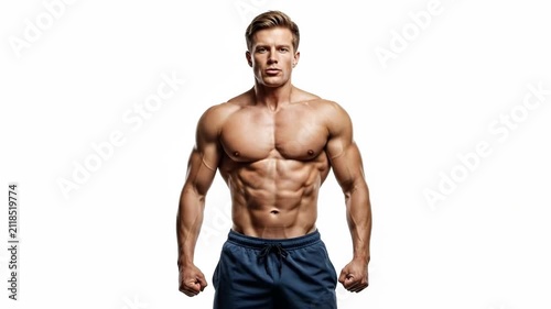 A shirtless muscular man with a defined physique posing against white backdrop