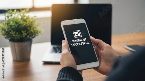 A person holding a mobile phone displaying a successful payment confirmation