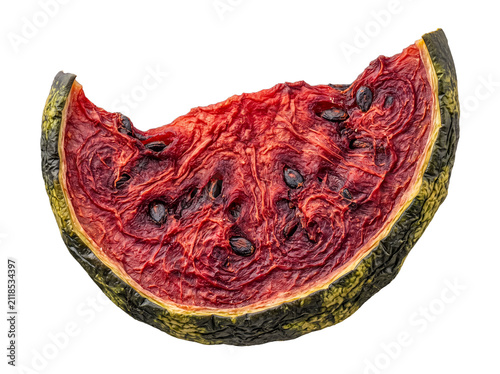 Detailed photograph of a severely withered watermelon slice, showcasing shrunken flesh and seeds.