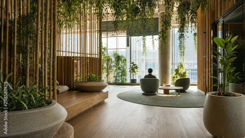 Man relaxing in a modern lounge with large windows and indoor plants