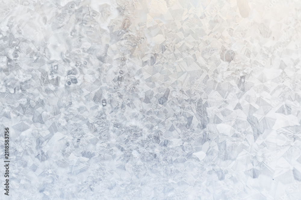 Obraz premium white winter background, frosty patterns on glass, abstract backdrop of ice and snow crystals in a blur