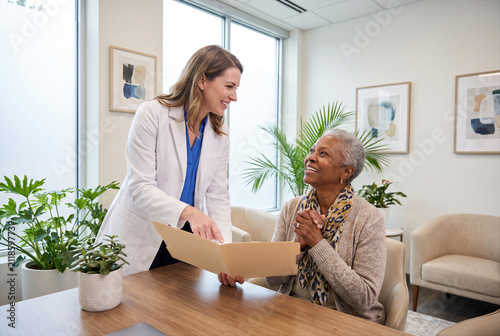 Doctor, physician or medical specialist explaining concerning examination, laboratory test, diagnosis or treatment results to patient, couple or family during serious healthcare consultation