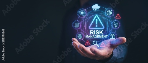 A person gripping a holographic interface showcasing risk management symbols illustrating business strategies and safety protocols within a digital landscape
