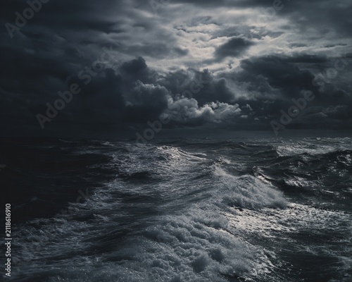 Dramatic seascape with turbulent waves under a stormy sky.