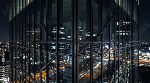 modern glass skyscraper facade at night