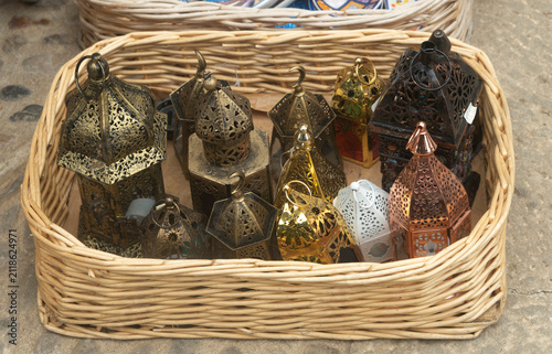 Wicker basket full of decorative Moorish style metal lanterns at a street market in Andalusia, Spain