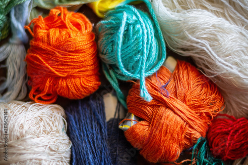 Small balls of recycled cotton and wool yarn. Concept of workcraft, recycled, reuse, secondhand.