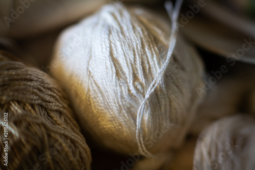Small balls of recycled  wool yarn. Concept of workcraft, reuse, recycling, handmade, recovery, secondhand