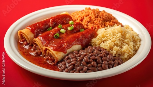 Beef enchiladas on a Mexican plate with Spanish rice and borracho beans, set against a red backdrop, topped with green scallions.