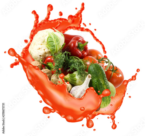 Fresh vegetables splash in red liquid creating a dynamic scene in the kitchen