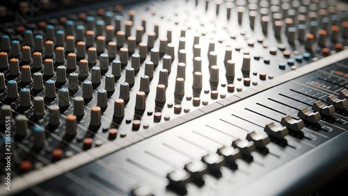 Professional audio mixing console with numerous knobs and faders for sound engineering and music production