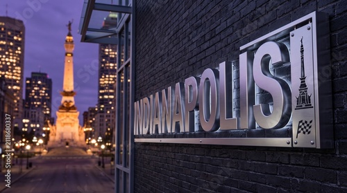 Indianapolis Motor Speedway Sign at Dusk with Monument