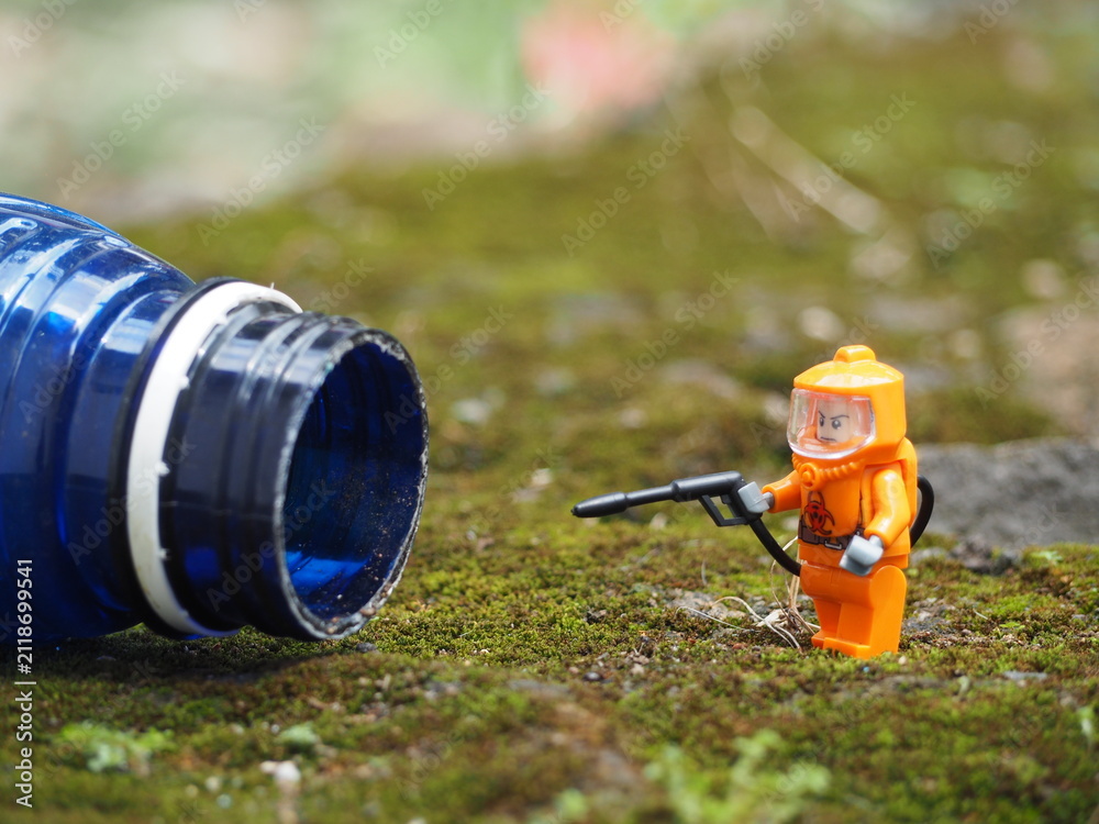 Fototapeta premium Indonesia - April 14, 2022 : Mini toy of action figure at table with blurred. Toy photography concept. Hazmat suit at outdoor conceptual design.