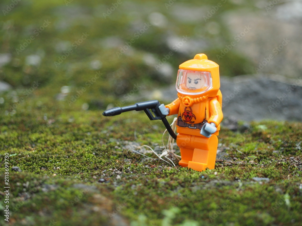 Fototapeta premium Indonesia - April 14, 2022 : Mini toy of action figure at table with blurred. Toy photography concept. Hazmat suit at outdoor conceptual design.