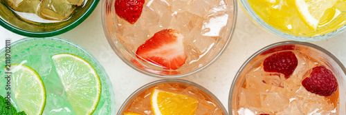 Colorful fruit drinks banner close up with ice and citrus