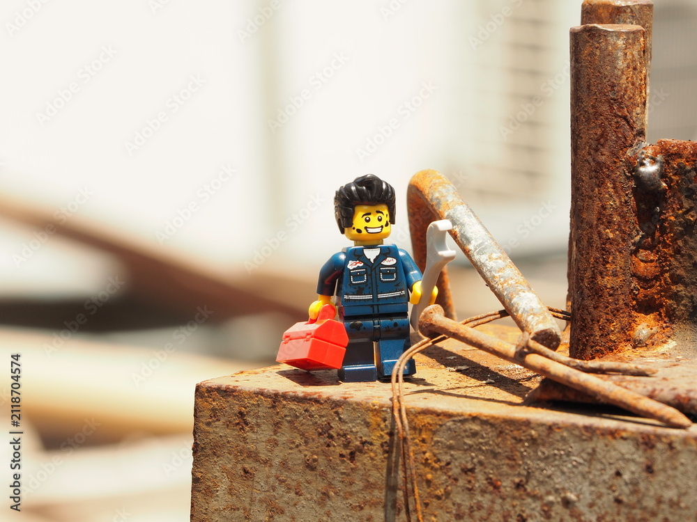 Fototapeta premium Indonesia - January 19, 2020 : Mini toy of action figure at table with blurred. Toy photography concept. Mechanical engineer conceptual design. Worker at site project with wrench tool.