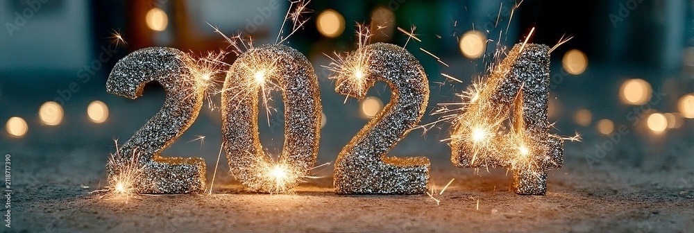 Obraz premium Glittering Silver 2024 Numbers Decorated With Bright Sparklers Against Seasonal Blurred Bokeh Bokeh.