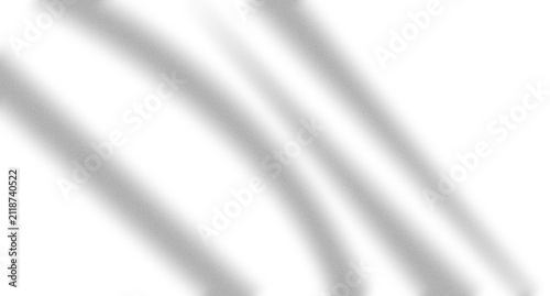 Abstract soft diagonal shadows of window blinds cast on a flat surface creating a minimalist aesthetic pattern