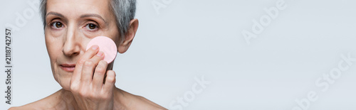 Фотография Senior woman embracing beauty with care routine in gentle light