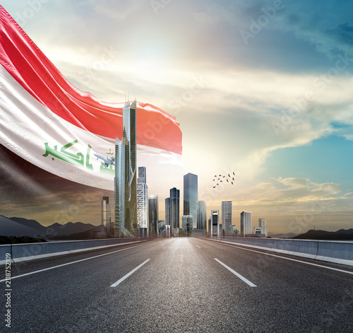 Canvas Print Iraq national flag waving behind the cityscape