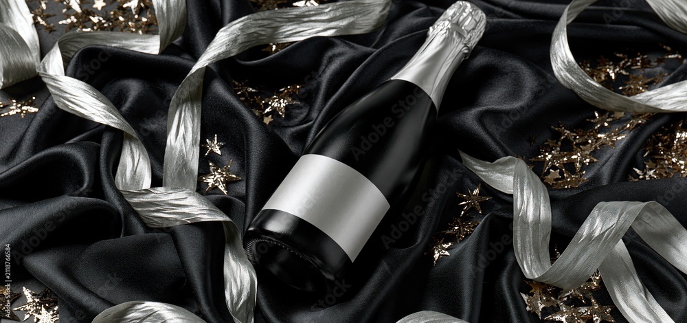 Obraz premium A sparkling wine bottle with a blank label set against black silk, accented by silver streamers and star confetti.