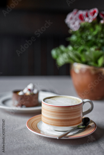 Obraz na plátně Cappuccino coffee mug with small chocolate cake dessert